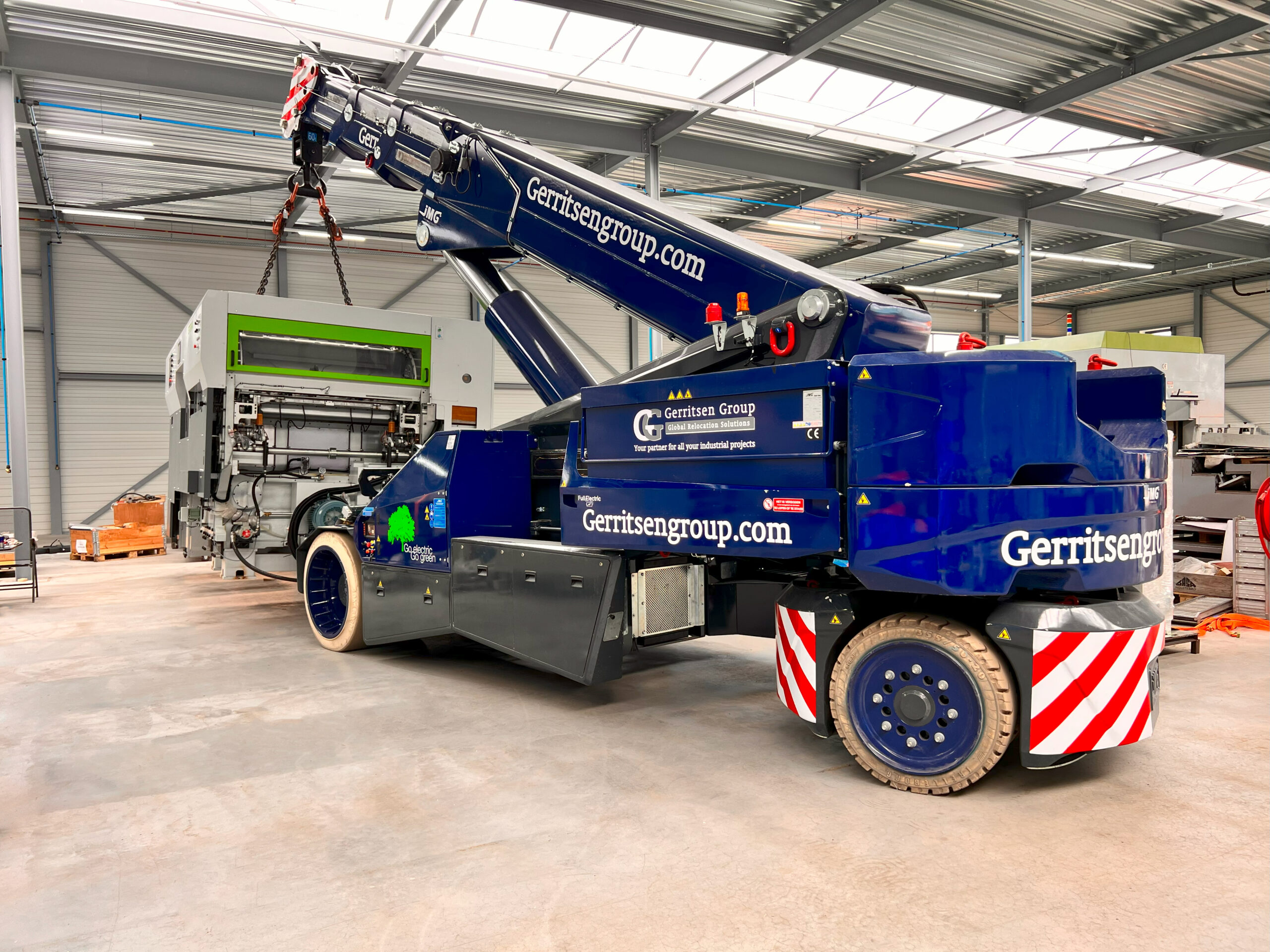 JMG pick and carry crane lifting a machine. 